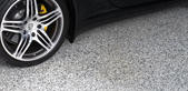 Photo of a Car Wheel on Tuxedo-Finished Epoxy Floor - epoxy floors texas