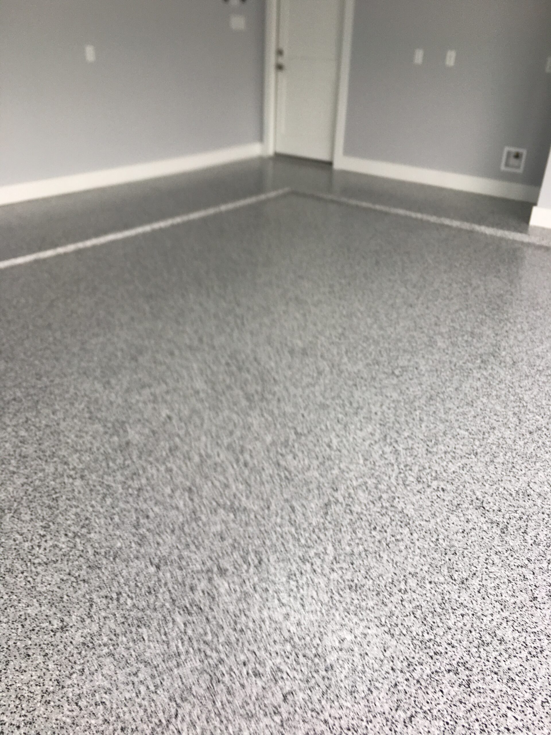 Photo from same project as Before Photo. Photo shows completed garage floor that has been prepped, epoxy coated, chipped and clear coated. What a difference!